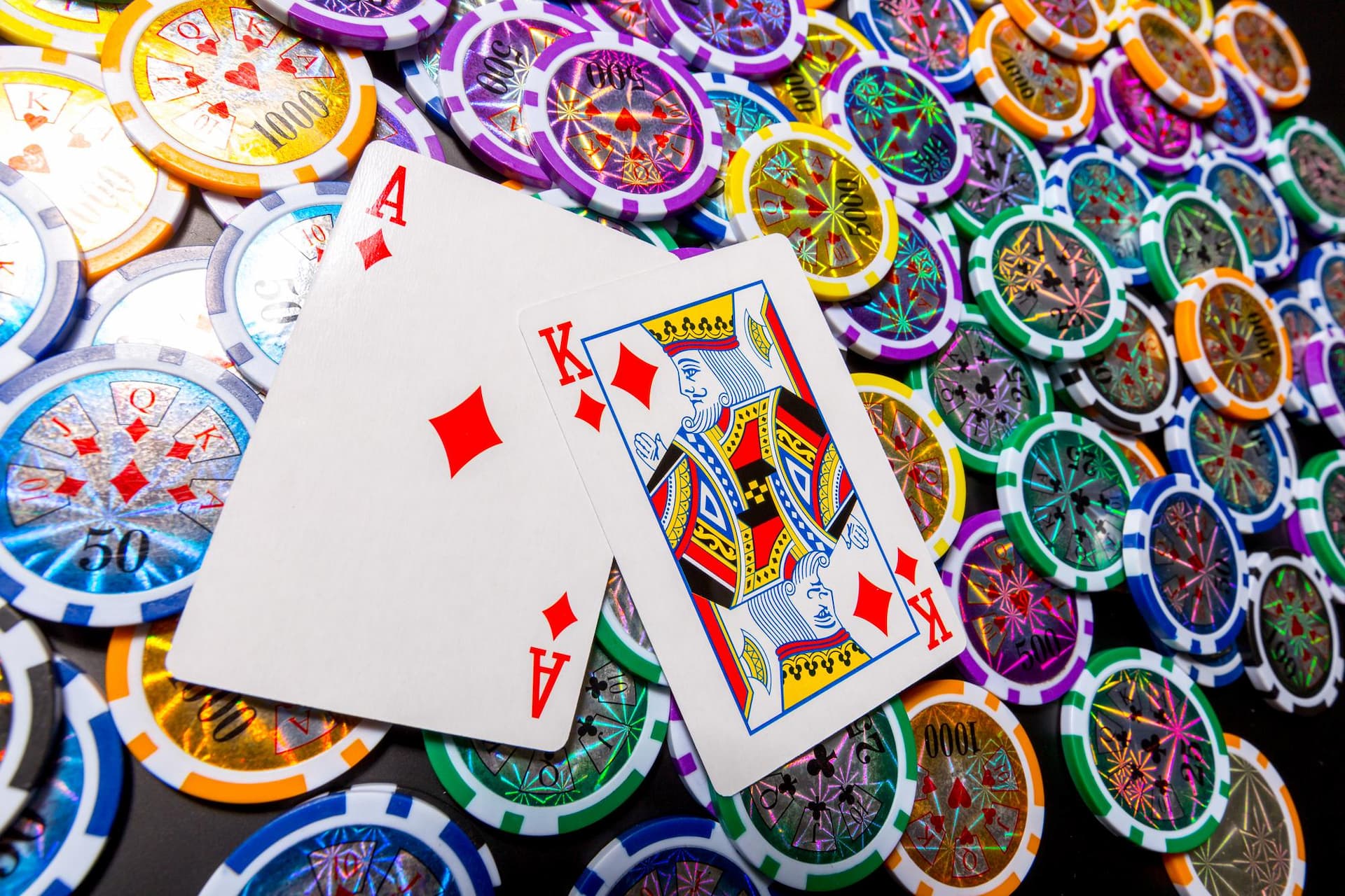 poker-chips-and-cards-on-black-background (1)